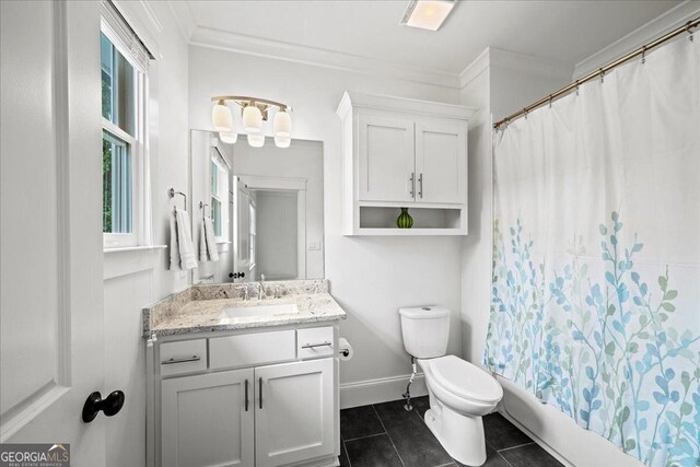 4048 Navajo Trl NE, Brookhaven, GA 30319 - full bathroom featuring vanity, toilet, tile patterned flooring, ornamental molding, and shower / bath combo with shower curtain