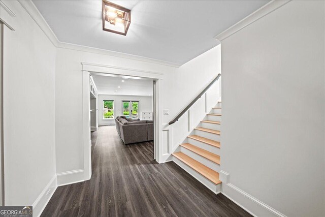 4048 Navajo Trl NE, Brookhaven, GA 30319 - laundry area with separate washer and dryer, cabinet space, crown molding, baseboards, and dark wood-style flooring
