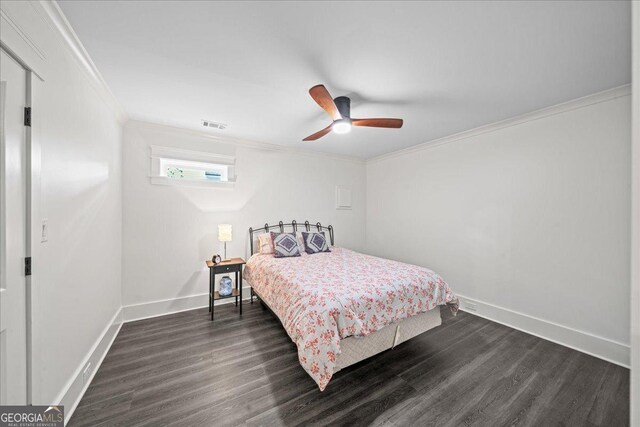 4048 Navajo Trl NE, Brookhaven, GA 30319 - bedroom with crown molding, dark wood-style floors, baseboards, and ceiling fan