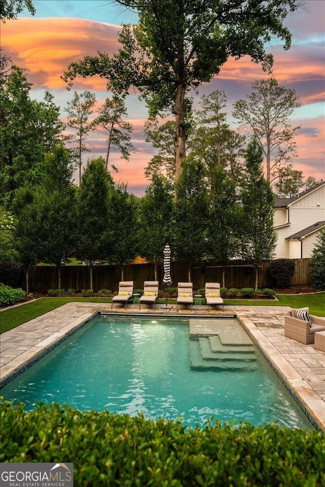 4048 Navajo Trl NE, Brookhaven, GA 30319 - pool at dusk with a patio area