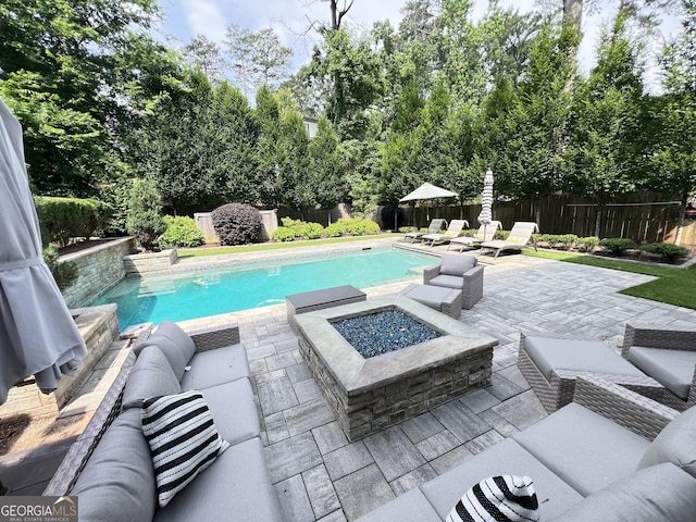 4048 Navajo Trl NE, Brookhaven, GA 30319 - view of swimming pool with a patio, a fenced backyard, view of scattered trees, and an outdoor living space with a fire pit