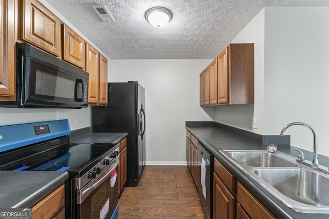 11439 S Grove Dr, Hampton, GA 30228 - kitchen featuring black appliances, a sink, dark wood-style flooring, dark countertops, and brown cabinetry