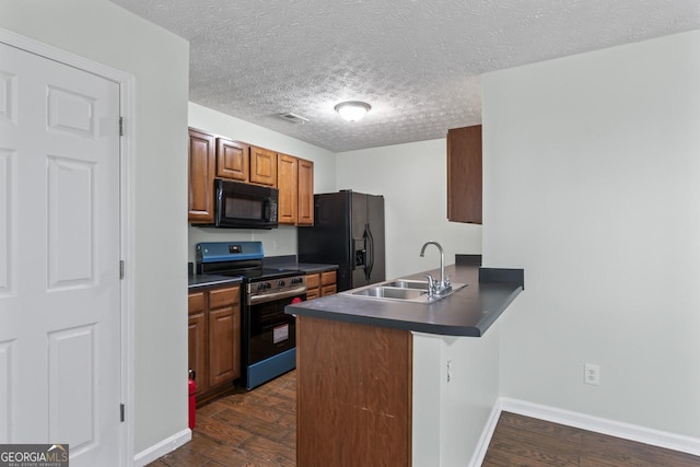 11439 S Grove Dr, Hampton, GA 30228 - kitchen featuring black appliances, dark countertops, a peninsula, dark wood-style floors, and a sink