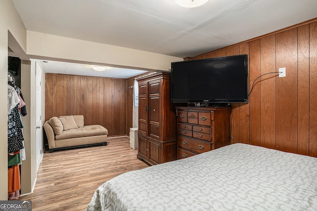 992 Brian Ln, Forest Park, GA 30297 - bedroom with light wood finished floors and wooden walls