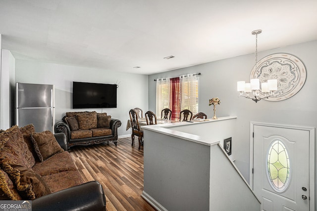 992 Brian Ln, Forest Park, GA 30297 - living area featuring dark wood-style flooring, a chandelier, and baseboards