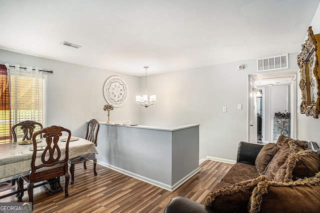 992 Brian Ln, Forest Park, GA 30297 - dining area with dark wood-type flooring, baseboards, and a chandelier