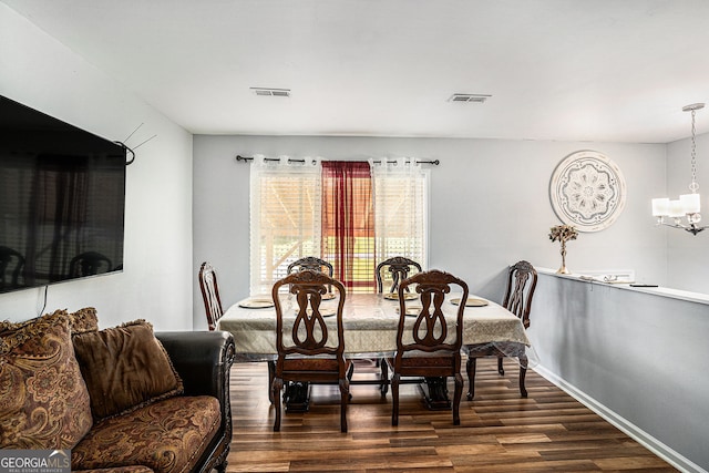 992 Brian Ln, Forest Park, GA 30297 - dining room with dark wood finished floors, a chandelier, and baseboards