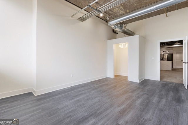 505 Whitehall St SW Unit 102, Atlanta, GA 30303 - spare room with wood finished floors, baseboards, and a high ceiling