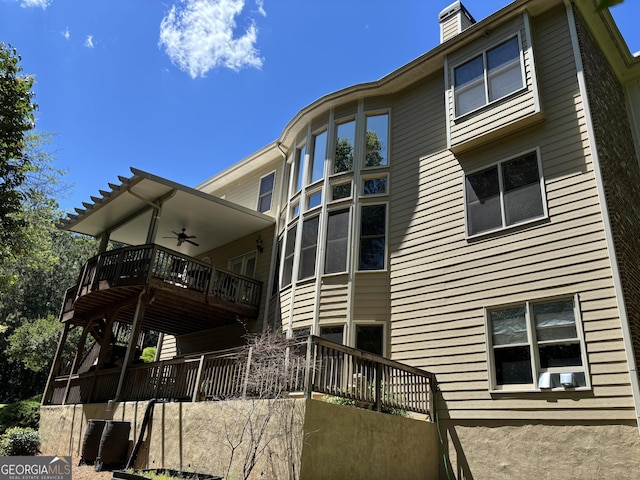 245 River Laurel Way, Woodstock, GA 30188 - back of property with ceiling fan, a chimney, cooling unit, a balcony, and a deck