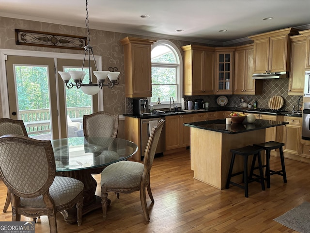 245 River Laurel Way, Woodstock, GA 30188 - kitchen with appliances with stainless steel finishes, a breakfast bar area, crown molding, a sink, and glass insert cabinets