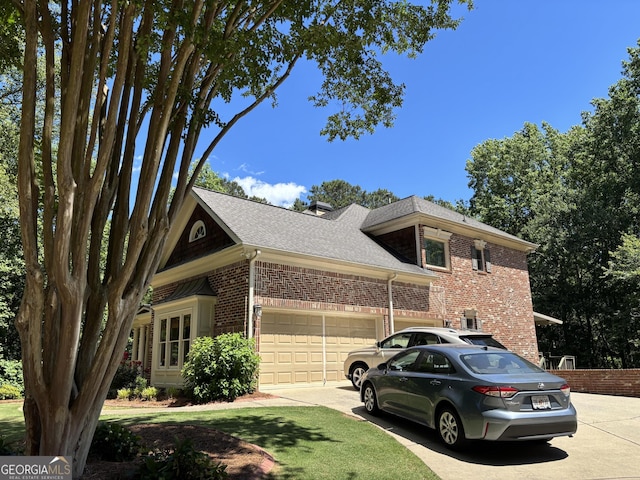 245 River Laurel Way, Woodstock, GA 30188 - view of front facade with brick siding, concrete driveway, a garage, and roof with shingles