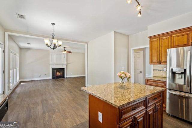 7025 Coffield Ct, Cumming, GA 30041 - kitchen with stainless steel fridge with ice dispenser, a chandelier, dark wood-style floors, a center island, and light stone countertops