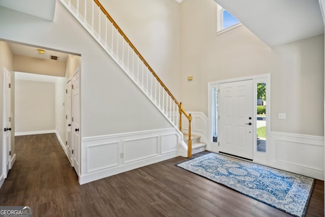 7025 Coffield Ct, Cumming, GA 30041 - entryway with stairs, wood finished floors, a wainscoted wall, a high ceiling, and a decorative wall