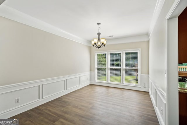 7025 Coffield Ct, Cumming, GA 30041 - unfurnished dining area with a chandelier, wainscoting, dark wood-style flooring, a decorative wall, and crown molding