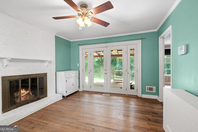 2933 King Alfred Dr, Macon, GA 31204 - unfurnished living room with wood finished floors, ornamental molding, ceiling fan, baseboards, and french doors