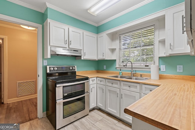 2933 King Alfred Dr, Macon, GA 31204 - kitchen with range with two ovens, under cabinet range hood, a sink, open shelves, and white cabinets