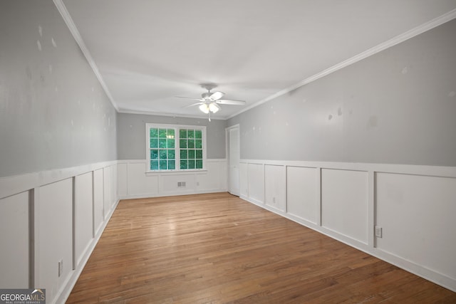 2933 King Alfred Dr, Macon, GA 31204 - spare room with ornamental molding, ceiling fan, wood finished floors, a wainscoted wall, and a decorative wall