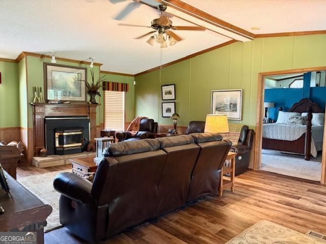 210 Vineyard Rd, Thomaston, GA 30286 - living area with wood finished floors, ceiling fan, ornamental molding, and a decorative wall