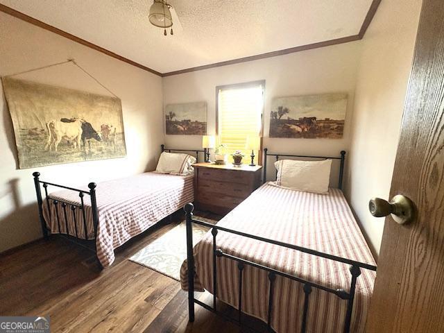 210 Vineyard Rd, Thomaston, GA 30286 - bedroom featuring crown molding, wood finished floors, and a textured ceiling