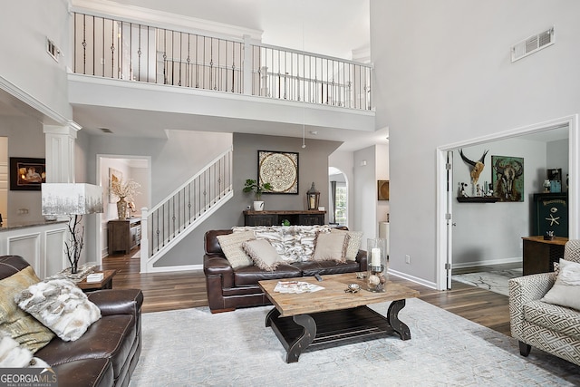 960 Pebblestone Ct, Alpharetta, GA 30009 - living area with wood finished floors, a high ceiling, stairway, baseboards, and arched walkways