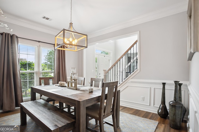 960 Pebblestone Ct, Alpharetta, GA 30009 - dining area with a chandelier, dark wood finished floors, ornamental molding, a wainscoted wall, and stairway