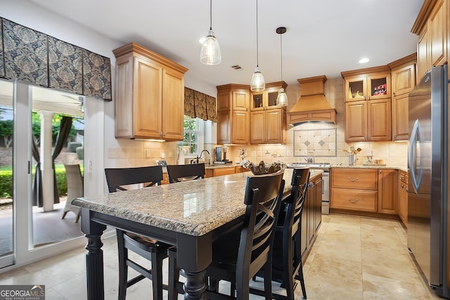 960 Pebblestone Ct, Alpharetta, GA 30009 - kitchen with custom exhaust hood, stainless steel appliances, light stone counters, backsplash, and a kitchen island