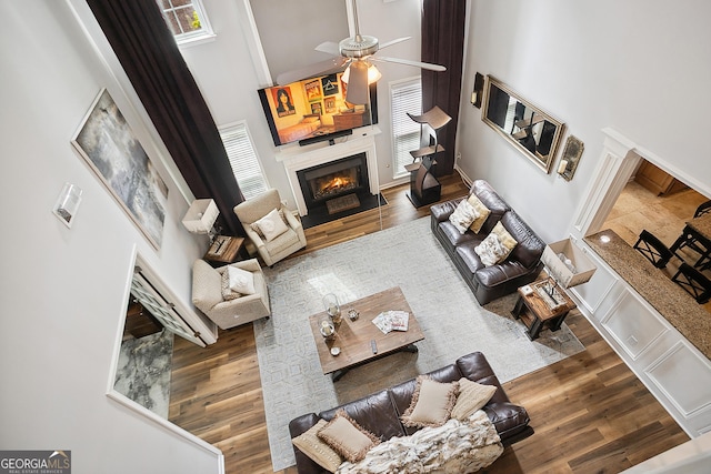 960 Pebblestone Ct, Alpharetta, GA 30009 - living area with a high ceiling, a fireplace with flush hearth, a ceiling fan, plenty of natural light, and wood finished floors