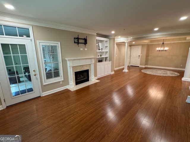 3047 Lenox Rd NE Unit 2105, Atlanta, GA 30324 - unfurnished living room featuring ornamental molding, wood finished floors, decorative columns, baseboards, and a fireplace