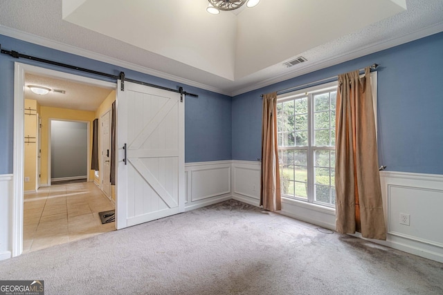 123 Chippewa Run, Auburn, GA 30011 - unfurnished room featuring a barn door, wainscoting, ornamental molding, carpet floors, and a decorative wall