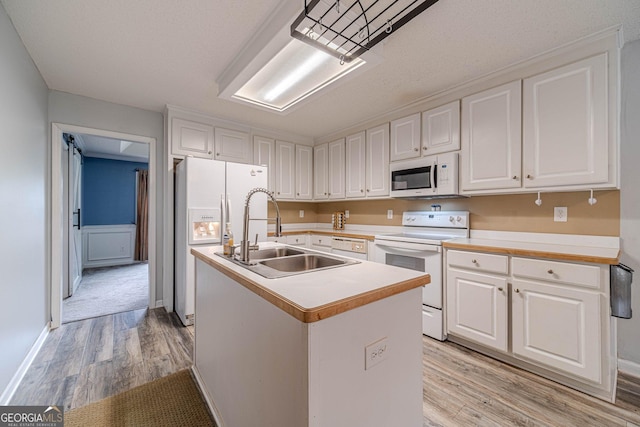 123 Chippewa Run, Auburn, GA 30011 - kitchen featuring white appliances, a sink, light wood-type flooring, and white cabinetry