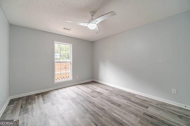 123 Chippewa Run, Auburn, GA 30011 - spare room with a ceiling fan, wood finished floors, a textured ceiling, and baseboards
