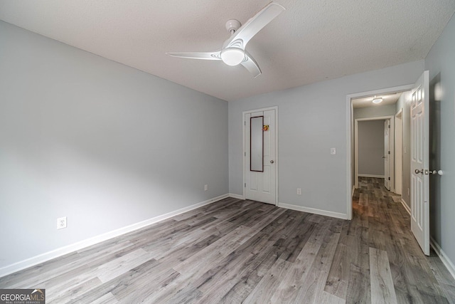 123 Chippewa Run, Auburn, GA 30011 - unfurnished bedroom with wood finished floors, a textured ceiling, baseboards, and ceiling fan