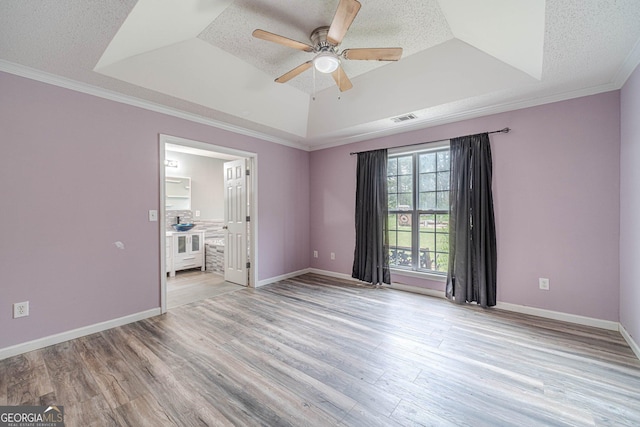 123 Chippewa Run, Auburn, GA 30011 - spare room with a raised ceiling, ceiling fan, light wood-type flooring, ornamental molding, and a textured ceiling