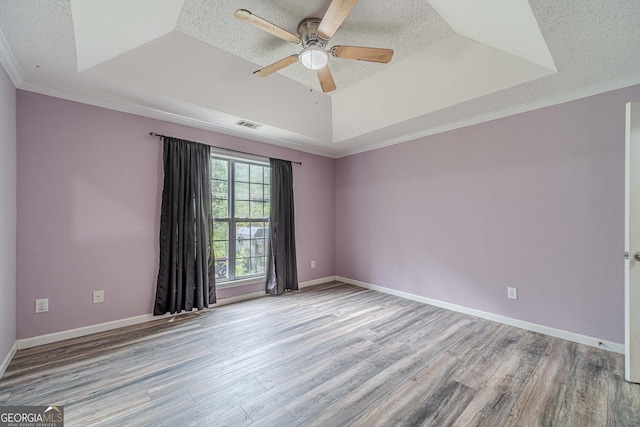 123 Chippewa Run, Auburn, GA 30011 - unfurnished room with a raised ceiling, wood finished floors, a ceiling fan, a textured ceiling, and baseboards