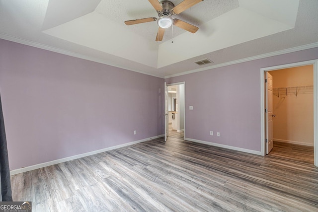 123 Chippewa Run, Auburn, GA 30011 - unfurnished bedroom with wood finished floors, a tray ceiling, baseboards, and ornamental molding