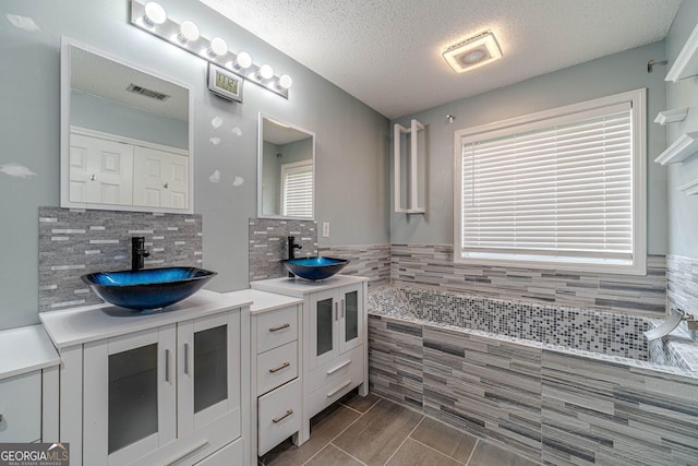 123 Chippewa Run, Auburn, GA 30011 - full bathroom featuring vanity, a textured ceiling, and plenty of natural light