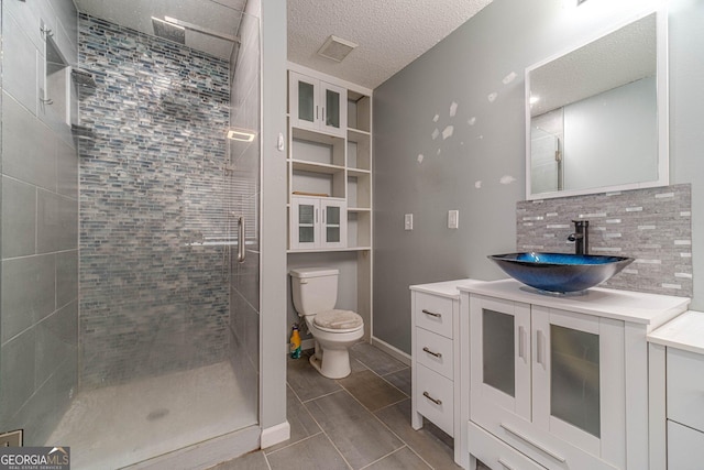 123 Chippewa Run, Auburn, GA 30011 - bathroom with a stall shower, toilet, vanity, a textured ceiling, and tile patterned floors