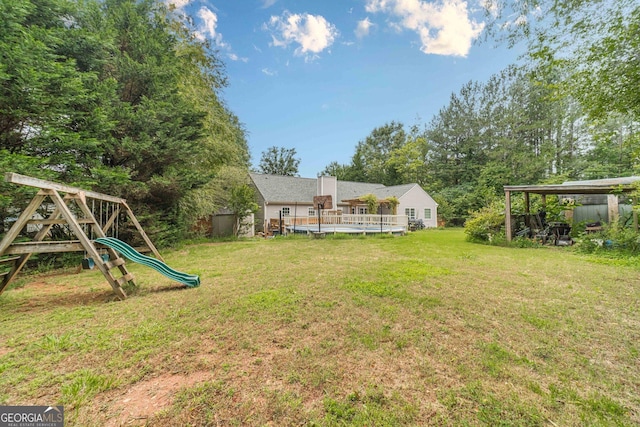 123 Chippewa Run, Auburn, GA 30011 - view of grassy yard featuring a playground and a wooden deck