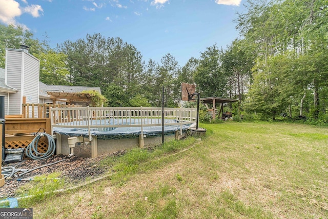 123 Chippewa Run, Auburn, GA 30011 - view of green lawn with a covered pool, view of scattered trees, and a deck