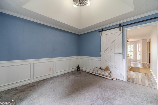 123 Chippewa Run, Auburn, GA 30011 - carpeted empty room featuring a barn door, a wainscoted wall, and crown molding