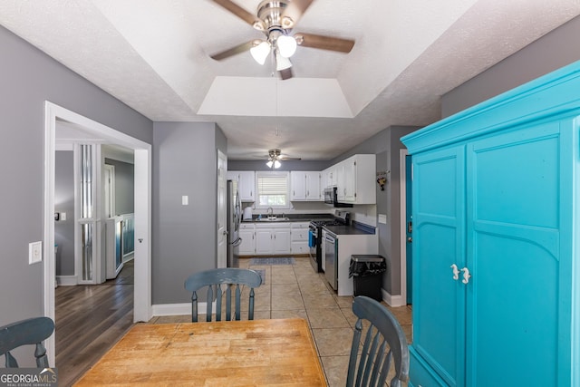 102 Fern Way, Thomaston, GA 30286 - kitchen featuring stainless steel appliances, ceiling fan, white cabinetry, and baseboards