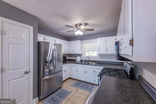 102 Fern Way, Thomaston, GA 30286 - kitchen featuring appliances with stainless steel finishes, a sink, dark countertops, white cabinets, and ceiling fan