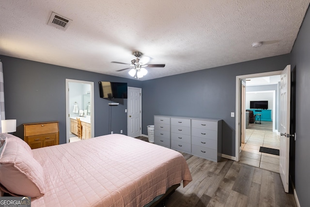 102 Fern Way, Thomaston, GA 30286 - bedroom featuring wood finished floors, baseboards, a textured ceiling, ensuite bathroom, and ceiling fan