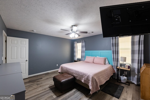 102 Fern Way, Thomaston, GA 30286 - bedroom with wood finished floors, ceiling fan, baseboards, and a textured ceiling