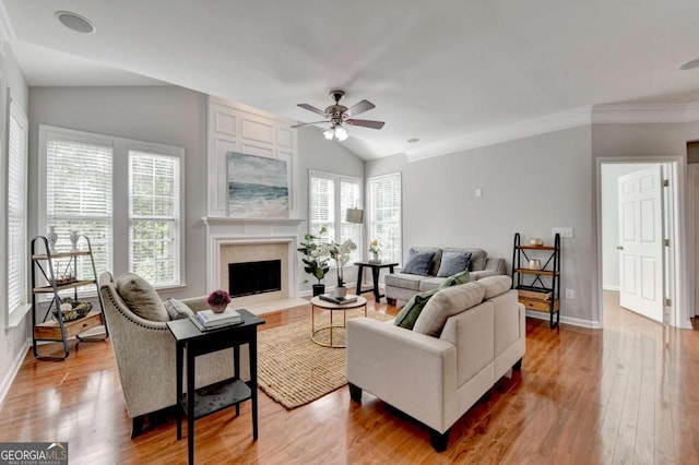 475 Bayswater Way, Suwanee, GA 30024 - living area featuring vaulted ceiling, light wood-type flooring, ceiling fan, a fireplace, and crown molding