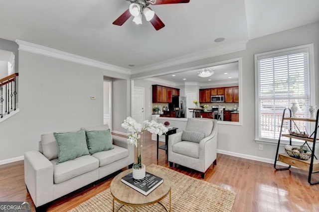 475 Bayswater Way, Suwanee, GA 30024 - living area with a ceiling fan, light wood-style floors, crown molding, and stairway