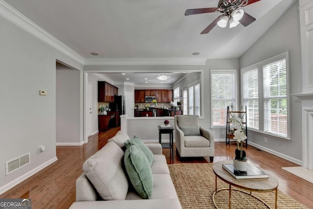 475 Bayswater Way, Suwanee, GA 30024 - living room featuring a ceiling fan, wood finished floors, ornamental molding, and vaulted ceiling