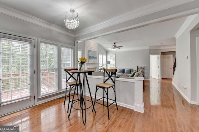 475 Bayswater Way, Suwanee, GA 30024 - dining area featuring ornamental molding, light wood-style floors, ceiling fan, and a chandelier