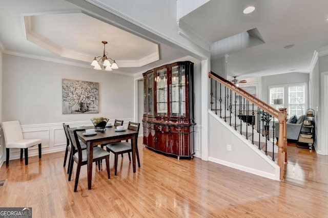 475 Bayswater Way, Suwanee, GA 30024 - dining room with a chandelier, light wood-style floors, crown molding, stairs, and a tray ceiling