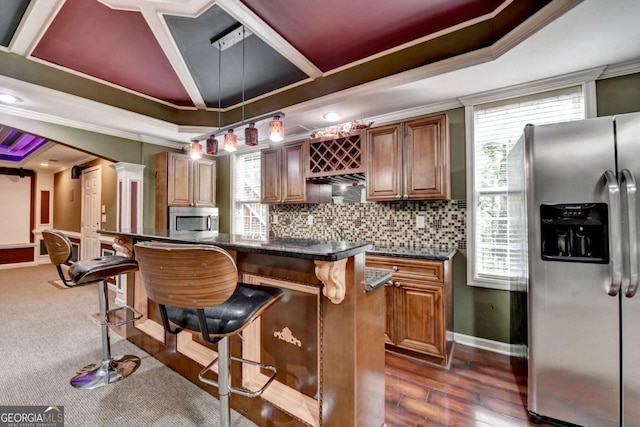 475 Bayswater Way, Suwanee, GA 30024 - kitchen featuring stainless steel appliances, a kitchen bar, tasteful backsplash, ornamental molding, and brown cabinets